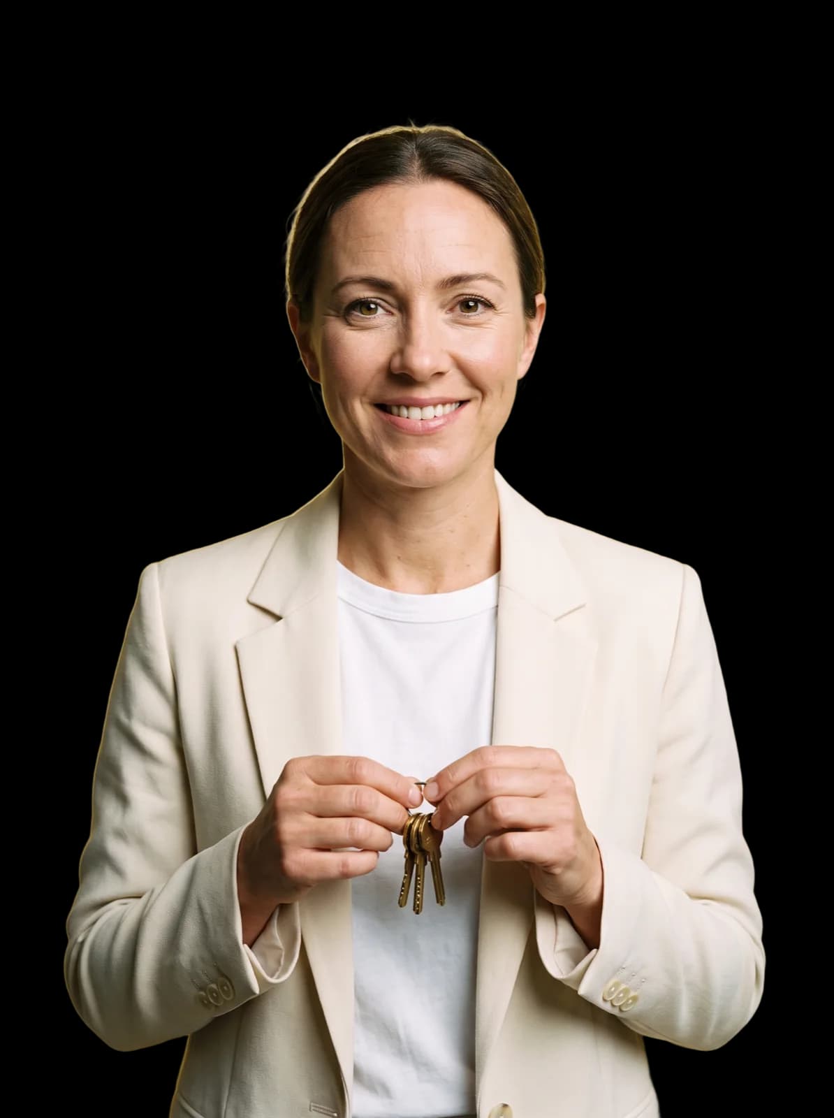 Eine Frau in cremefarbenem Blazer hält lächelnd einen Schlüsselbund vor gelbem Studiohintergrund